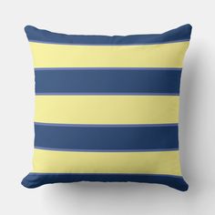 a blue and yellow striped pillow on a white wall