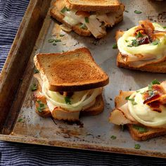 toasted sandwiches topped with bacon and cheese on a baking sheet, ready to be eaten