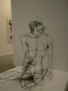 a black and white photo of a wire sculpture