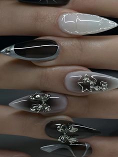 three different nail designs with silver and black accents on their fingers, one in the shape of a flower