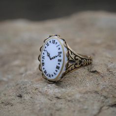 Victorian style German Clock Face Cameo.  Available on an antiqued brass or silver vintage ring.I do not recommend that this be worn while bathing or swimming although normal handwashing is fine.The cameo is an image of a clock face and not a working time piece.  Click link for matching clock face necklace:  https://www.etsy.com/listing/1004126650/vintage-clock-face-cameo-necklace-inCuff Bracelet:  https://www.etsy.com/listing/1016463290/cameo-clock-face-cuff-bracelet-in German Clock, Purple Lady, Book Locket, Face Necklace, Cameo Jewelry, Cameo Ring, Vintage Cameo, Brass Bracelet, Cameo Necklace