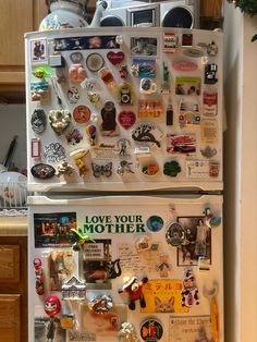 two refrigerators with magnets on them in a kitchen