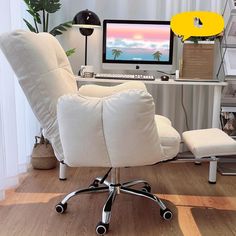 a white chair sitting in front of a computer on top of a wooden floor next to a desk