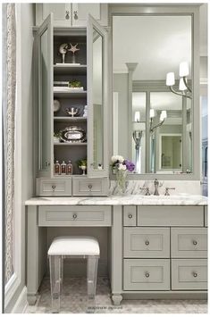 a bathroom with two sinks and a large mirror over the sink, along with a stool