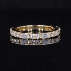 an image of a wedding ring with diamonds on it's sides and in the middle