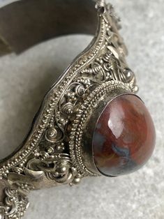 "Old Asian Doubble Dragon 900 Silver Red Marbled Agate Vintage Bracelet marked 90% near the Clasp. weighs 30g. 1 1/2\" wide At the widest The inside Circumstance is 7 1/2\". This bracelet is beautiful and does show age, please view pictures carefully for they are a large part of the description" Traditional Gemstone Cuff Bracelet, Artisan Gemstone Bracelets, Silver Agate Gemstone Cuff Bracelet, Traditional Agate Bracelet, Traditional Agate Jewelry For Collectors, Traditional Agate Bracelet Jewelry, Vintage Red Gemstone Bracelets, Unique Red Gemstone Bracelet, Unique Red Gemstone Bracelets