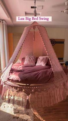 a bed with pink sheets and pillows in a room