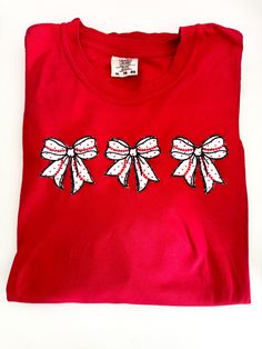 Perfect for you or a gift for teammates, coach or a Team Mom.  Applique embroidered bows with tiny dot red fabric and baseball softball laces.   Whether at the game or hanging out with teammates after practice or during tournaments, this amazing shirt will set you apart!   Affordable and roomy and great for holiday or Christmas gifts, as well as season gifts or matching team travel. This shirt is in XL red, but I can make as many as you want, in whatever colors and sizes you want.  I will update Gift Red Embroidered Top, Red Embroidered Tops Gift, Red Embroidered Top For Gift, Red Embroidered Tops As Gift, Red Embroidered Holiday Tops, Team Mom Gifts, Travel Ball, Embroidered Bows, Team Mom