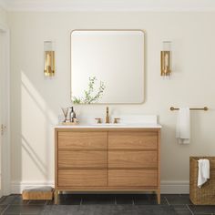 a bathroom with a sink, mirror and basket on the floor in front of it