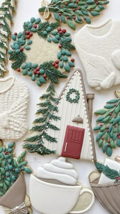 christmas cookies are arranged on a table with holly wreaths and other holiday decorating items