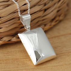 This is solid 925 sterling silver rectangular shape photo locket pendant.  925 stamped.  The locket is plain highly polished on both sides.       Approx. measures:             total length: 30 mm            without bail: 20 mm           width: 16 mm   Approx. pendant only weight:  5.1grams. Available on its own or with various length (16-30 Inch) 1mm curb chain, please choose from the drop- down menu at the top of the page. Presented in gift box. Thank you for looking! Silver Rectangular Necklace With Polished Finish, Rectangular Locket Necklace For Anniversary, Italy Jewelry, Necklace Gift Box, Locket Pendant Necklace, Photo Locket, Sterling Silver Flowers, Silver Flowers, Curb Chain