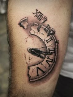 a man's arm with a clock tattoo on it