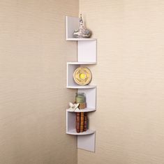 a corner shelf with three shelves on the wall