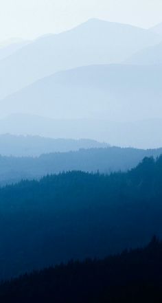 the mountains are covered in fog and haze