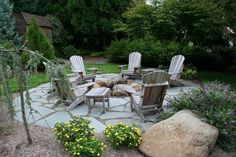 a stone patio with chairs around it