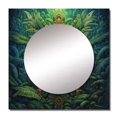 a round mirror sitting in the middle of a forest filled with green plants and leaves