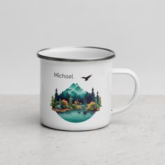 a white enamel mug with the words michael on it and an image of a mountain lake