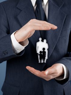 a man in a business suit holding out his hands with a paper cutout of two people