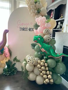 balloons are stacked on top of each other in front of a dinosaur balloon arch that reads, summer three - rex