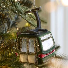 an ornament hanging from a christmas tree in the shape of a trolley car