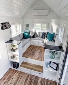 the interior of a tiny home with white walls and wood flooring