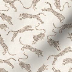 a white fabric with brown leopards on it's back and the background is made up