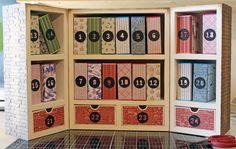 an open book case with lots of books on the shelves and numbers painted on it