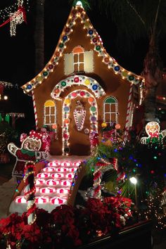 a house covered in christmas lights and gingerbreads for the holiday season is shown