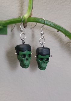 These polymer clay skull earrings are all ready for spooky season with their adorable Halloween costumes. Available in Cat ears, Frankenstein, or Witch Hat. Each one is double sided, so they look great no matter which way they fall. These are perfect for any Fall activity. *Handmade from polymer clay and very lightweight. Stainless steel,  nickel free findings. *Each pair is individually handmade to order, so please allow up to 48 hours for creation process, before shipping.  *All items are handmade, with love, by me. No two items are the exact same. Green Novelty Earrings For Halloween, Green Novelty Jewelry For Halloween, Adorable Halloween Costumes, Clay Skull, Witches Cat, Fall Activity, Skeleton Earrings, Clarksville Tn, Witch Cat