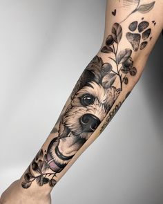 a tattoo on the arm of a person with a dog and flowers in it's head