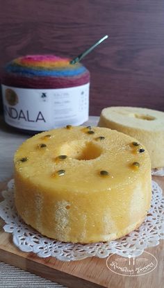 a cake on a doily next to a jar of yogurt