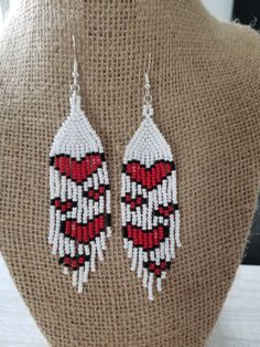 the beaded earrings are on display on a mannequin