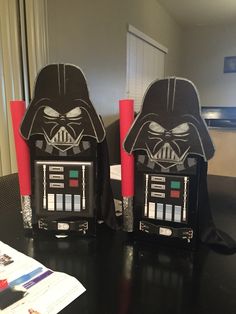 two darth vader themed speakers sitting on top of a table