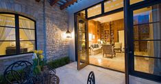 an outdoor living room and dining area at night