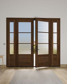 an empty room with two wooden doors and a white rug in front of the door