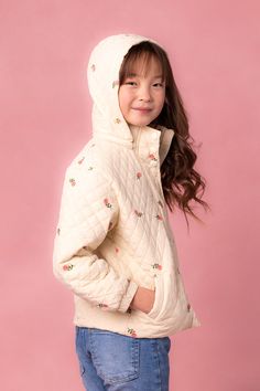 Expertly crafted and elegantly designed, our Mini Quilted Jacket in Delicate Zinnia boasts a cream base color adorned with a pink zinnia floral print. Featuring intricate quilt embroidery and the coziest fit. Details include a detachable hood, elastic ruched cuffs and functional pockets. This darling puffer coat offers both style and functionality, perfect for your little gal. Intricate Quilt, Pink Zinnia, Quilt Embroidery, Cream Base, Fit Details, Mini Quilt, Cozy Fits, City Girl, Detachable Hood