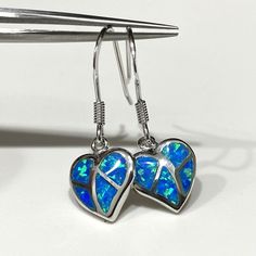 Vintage Sterling Silver Blue Opal Heart Dangle Earrings....Marked 925...Total of weights 3.1grams...Measure H 1 2/8'' W 3/8''...These are in very good condition. Blue Heart-shaped Earrings For Anniversary, Blue Sterling Silver Heart Earrings For Valentine's Day, Blue Sterling Silver Heart Dangle Earrings, Blue Sterling Silver Heart Cut Earrings, Blue Dangle Heart Pierced Earrings, Blue Pierced Heart Drop Earrings, Blue Pierced Heart Earrings, Blue Heart-shaped Sterling Silver Earrings, Blue Sterling Silver Heart Earrings For Pierced Ears