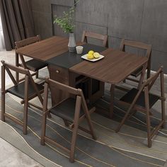 a dining table with four chairs and a bowl of lemons on the table next to it