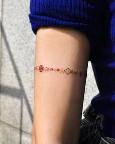 a person with a small tattoo on their arm