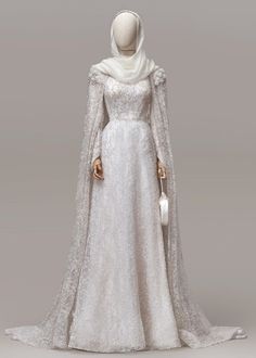 a white gown with long sleeves and a shawl