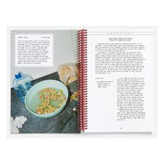 an open book with pictures of cereal and water on the cover, next to a bowl of cereal