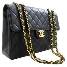 An authentic CHANEL Classic Large 11" Chain Shoulder Bag Flap Black made of black Lambskin. The color is Black. The outside material is Leather. The pattern is Solid. This item is Vintage / Classic. The year of manufacture would be 1996-1997. Conditions & Ratings Outside material: Lambskin Color: Black Closure: Turn Lock Hardware and chain: Gold-Tone Made in France Serial sticker: Attached Comes with: Dust bag, Box Bag Overall: 8 of 10 - The outside is in excellent condition with minimal signs o Vintage Chanel Bag, Chanel Suit, Structured Shoulder, Chanel Brand, Chanel Flap Bag, Chanel Mini, Chain Gold, Box Bag, Chanel Black