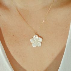 Discover the delicate essence of femininity with our Lily Necklace. Each flower pendant is hand-cut from a unique shell by a skilled Venezuelan artisan. This beautiful flower necklace, made in 14k gold-filled, is perfect for wearing alone or layering with other necklaces. Handcrafted in the USA. DETAILS: Water-resistant, skin friendly Material: 14/20 gold filled, shell nacre Pendant Size: 22mm aprox Each necklace comes with an adjustable extender chain 2 inches. Lily Necklace, 40th Gifts, Beaded Cuff, 30 Gifts, Chain Choker, Cuff Bangles, Flower Pendant, Flower Necklace, Beautiful Flower