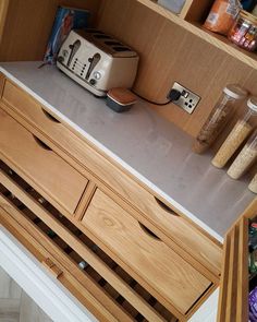 a toaster and other kitchen items sit on the counter top in a pantry area