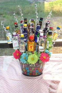 a bucket filled with lots of bottles on top of a table