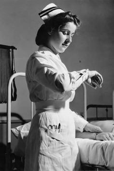 an old photo of a nurse tending to a patient