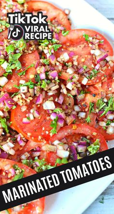 sliced tomatoes and chopped herbs on a white platter with text overlay that reads marinated tomatoes