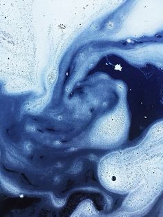 an abstract blue and white painting with bubbles