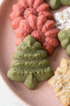 a pink plate topped with different types of cookies