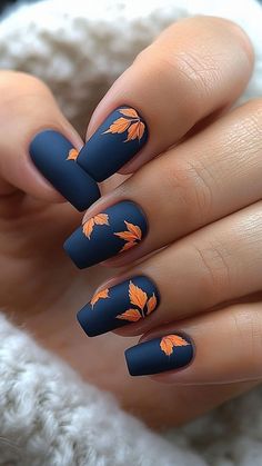 Matte blue nails with orange leaf designs create a striking and unique fall manicure. This bold color combo perfectly captures the essence of autumn. Click the pin and follow us for more stylish nail ideas! #MatteNails #BlueNails #OrangeLeafDesigns #FallManicure #NailInspo Matte Orange Nails Short, Teal And Mustard Nails, Fall Mat Nails Ideas, Fall Nail Designs Navy Blue, Blue Pumpkin Nail Art, Leaf Pattern Nails, Autumn Leaf Nails Design, Fall Ideas Nails, Fall Nails With Teal